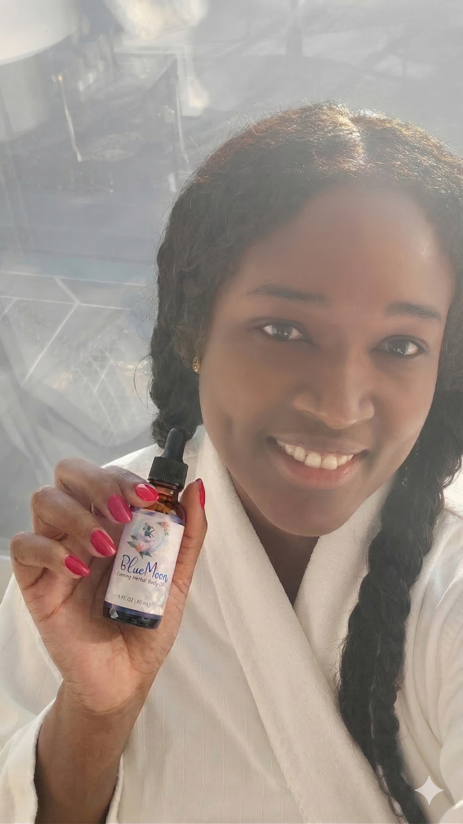 Tamie Myers, herbalist and founder of Asana Crystal, holding the Blue Moon Evening Herbal Body Oil